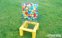 a basket filled with balls sitting on top of a green field