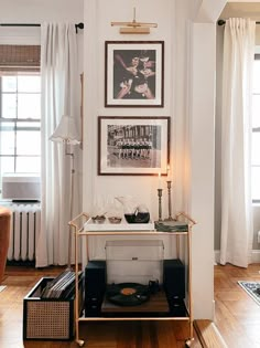 a living room filled with furniture and pictures on the wall