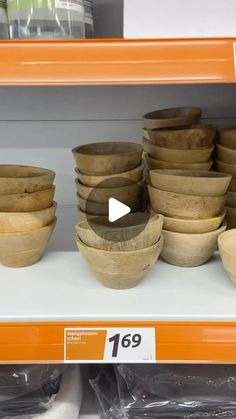 wooden bowls are on display in a store