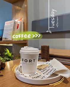 a coffee cup sitting on top of a wooden table