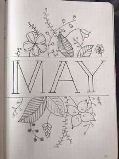 an open notebook with the word may written on it and flowers in the middle, surrounded by smaller doodles