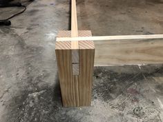 a piece of wood sitting on top of a floor next to a wooden frame and plywood