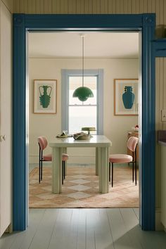 an open door leading to a dining room with chairs and a table in the center