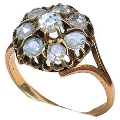 a gold ring with white stones on it