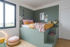 a bedroom with green walls and stairs leading up to the bed area is decorated in pastel colors