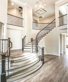 a large open floor plan with stairs and chandelier