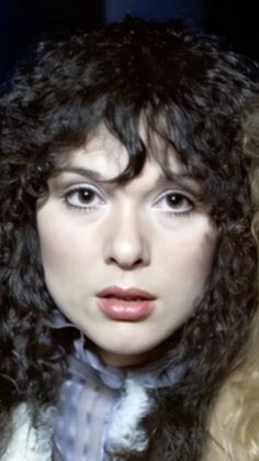 a close up of a person with curly hair