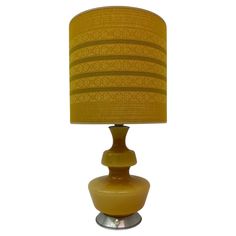 a table lamp with a yellow shade on it