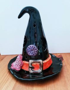 a black witch's hat sitting on top of a wooden table