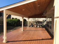 an outdoor covered patio with wood flooring and hard wood planks on the sides