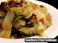 a white plate topped with cabbage and bacon