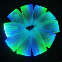 a blue and green light up flower in the dark