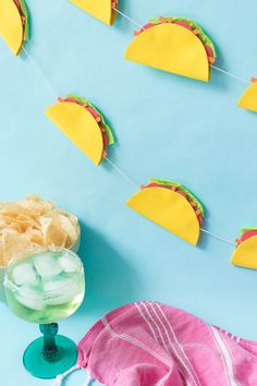 some tacos and drinks on a blue table