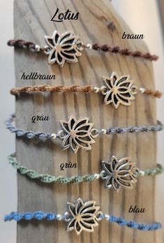 four bracelets with different designs on them and the words lotus written in white letters