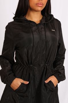 Brand new for SS24, introducing our Light Weight Hooded Jacket in black. Perfect for wearing and layering over any of your Sculpt sets whilst heading to the gym or whilst out and about. Reworked from our previous jackets, it features a drawstring hood to keep you dry from the rain, two front pockets for extra storage and waist toggles for an adjustable fit. Drawstring Hood Waterproof Full Zip Two Front Pockets Regular Fit Metal Logo Tag Elasticated Waist & Cuffs on Arms Black Colour Waist Toggles For Adjustable Fit Machine Wash According To Label 100% Polyester Model is 5ft 3" and wears a size XS. Out And About, Extra Storage, Metallic Logo, Long A Line, The Gym, The Rain, Hooded Jacket, Layering, Active Wear