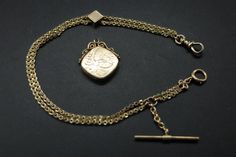 "14Kt Yellow Gold Vest Pocket Watch Chain in Very Fine (Excellent) Condition. Fancy Double Strand Chain with Engraved Slide. 14K mark is inside the Swivel. Kassoy Acid Tests - Chain, T-Bar, Swivel and Flower Engraved Slide all test 14Kt Gold. The Locket Fob is Gold Filled and Engraved with an Ocean Scene with Waves facing a House on the Shore -marked W+H Shell Co. Owner acquired Locket Fob Later. The Double Chain measures 10 1/2\" Long and 2.5mm Wide. It weighs 14 grams (without the Locket Fob). Vest Chain, Gold Vest, Gold Slides, Gold Pocket Watch, Diamond Girl, Pocket Watch Chain, Pocket Watches, Rope Design, Watch Chain