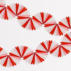 several red and white paper fans arranged in the shape of a heart