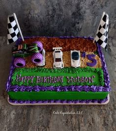 a birthday cake decorated with cars and checkered flags