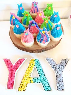 the word may spelled out with cupcakes and candy