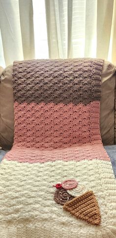 a crocheted blanket on the back of a couch