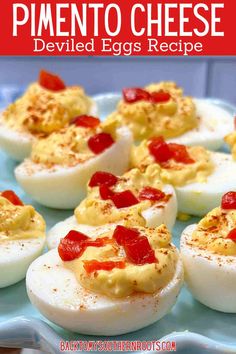 deviled eggs are topped with cheese and ketchup on a blue platter