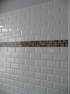 an image of a bathroom with white tiles on the wall