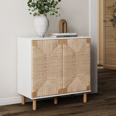 a plant is sitting on top of a cabinet in a room with white walls and flooring