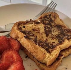 two pieces of toast and strawberries on a plate