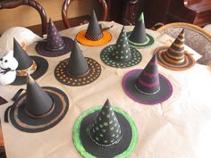 a table topped with lots of witches hats