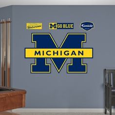 michigan wolverines wall decals with the word michigan on it in blue and yellow