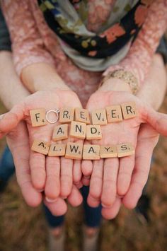 two hands are holding scrabble letters that spell out the word forever and always