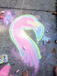 a pink flamingo drawn on the sidewalk with chalk crayons next to it