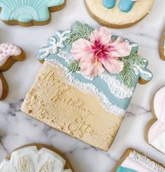 decorated cookies with frosting and decorations on a marble surface