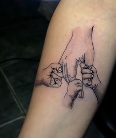 two hands holding each other on the left side of the arm, with black ink