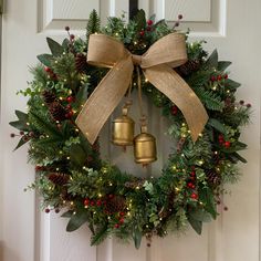 a wreath with two bells hanging from it