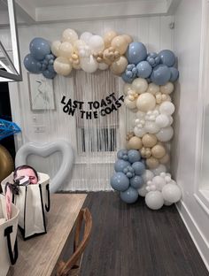 balloons and streamers are arranged in the shape of a heart at this birthday party