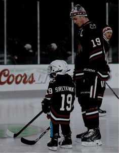 two young hockey players are standing on the ice