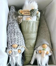 three gnomes made out of knitted items in a box with labels on them