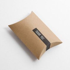 a brown paper bag sitting on top of a white table