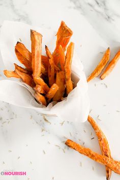 some kind of food that is in a paper bag on a table with other foods