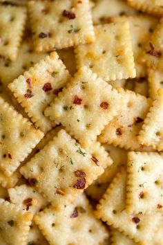 some crackers are sitting on top of each other and sprinkled with seasoning