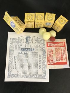 an assortment of chinese soaps and other items laid out on a black table top