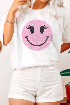 Wink Smiley Face Graphic T-Shirt. Designed for comfort and style. 100% Premium Cotton Unisex Sizing Classic Fit Fun Spring T-shirt With Sublimation Print, Fun T-shirt With Sublimation Print For Spring, White T-shirt With Funny Print For Spring, Cute White Cotton T-shirt, Cute White Short Sleeve T-shirt, Fun White T-shirt, Fun White Everyday T-shirt, Trendy White T-shirt With Text Print, Pink Graphic Tee With Smiley Face