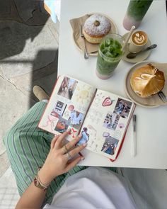 a person sitting at a table with an open book in front of them and food