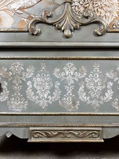 an ornately painted chest of drawers on display