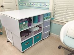 a white desk with blue bins and drawers