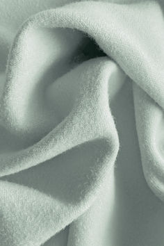 a close up view of a white fabric with very soft folds on the top and bottom