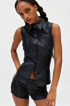 Modern Silence + Noise top & short set in a sleek faux leather construction. Features a button-front vest top with a collared neckline and slim micro shorts. Find it only at Urban Outfitters. Features Silence + Noise Chloe faux leather vest top & micro short set Faux leather shirt and short set Sleep faux leather fabric Collared neckline and sleeveless Button-front with double breasted pockets Low rise waistline Slim tailored fit Micro length Button closure top Zip fly & button closure short UO Fitted Faux Leather Jacket With Buttons, Fitted Fall Vest With Snap Buttons, Trendy Fitted Leather Jacket With Button Closure, Fitted Leather Button-up Top, Fitted Leather Jacket With Button Closure For Night Out, Fitted Faux Leather Top For Work, Fitted Faux Leather Tops For Work, Chic Fitted Leather Vest, Edgy Fitted Vest For Workwear