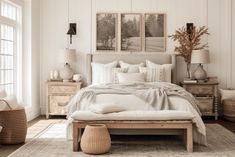 a bed with white linens and pillows in a bedroom next to two pictures on the wall