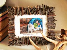 a frame made out of sticks with a nativity scene in the center and an antler next to it